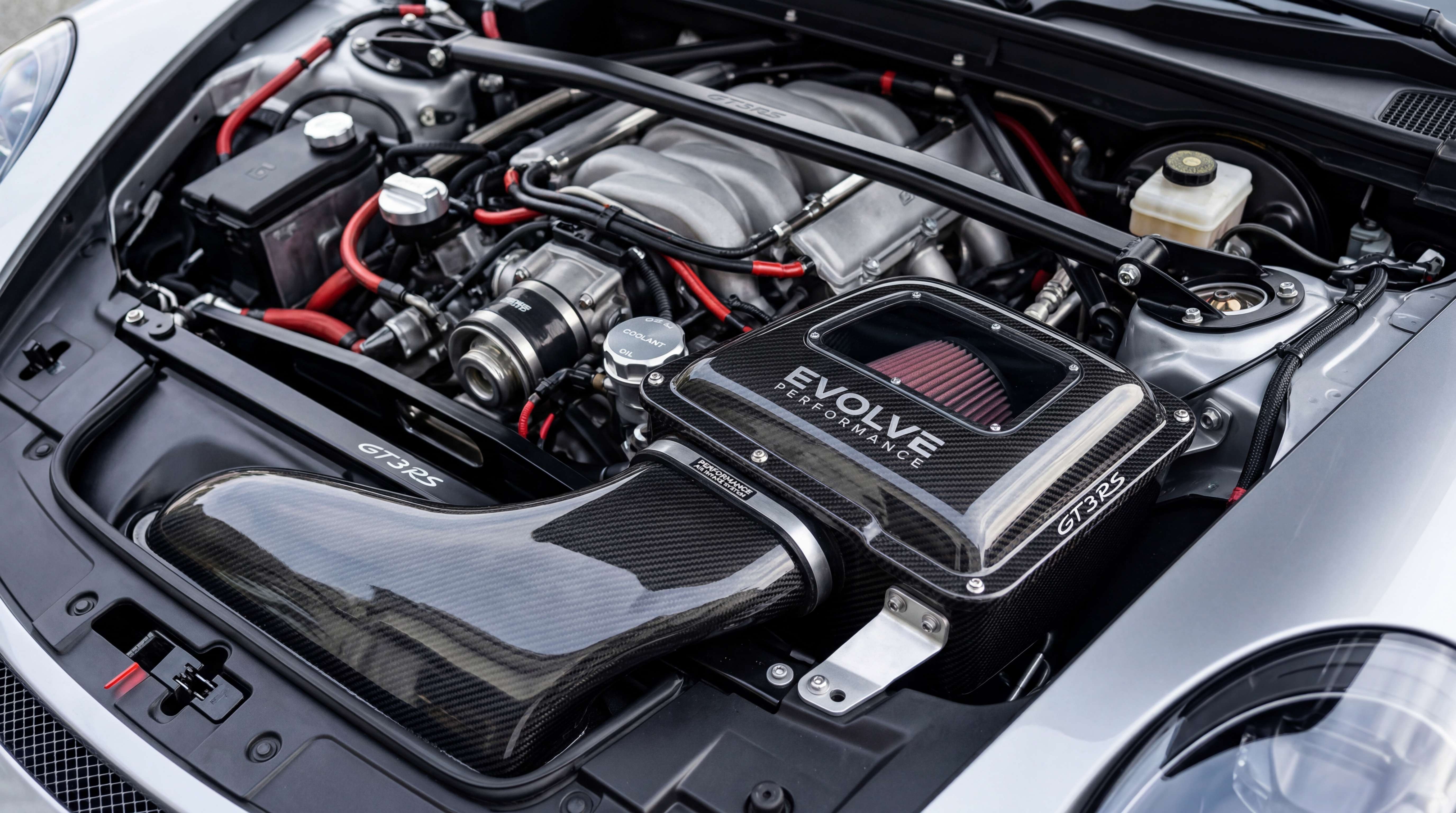 Enclosed carbon fiber cold air intake system installed in an engine bay for better intake heat management and air temperature control